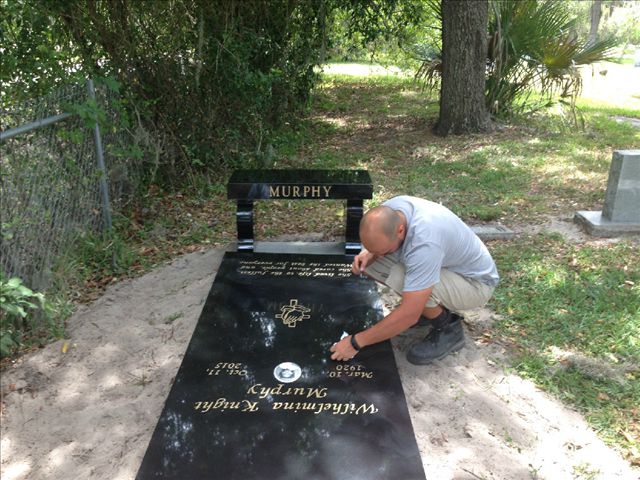 black headstone with gold lettering