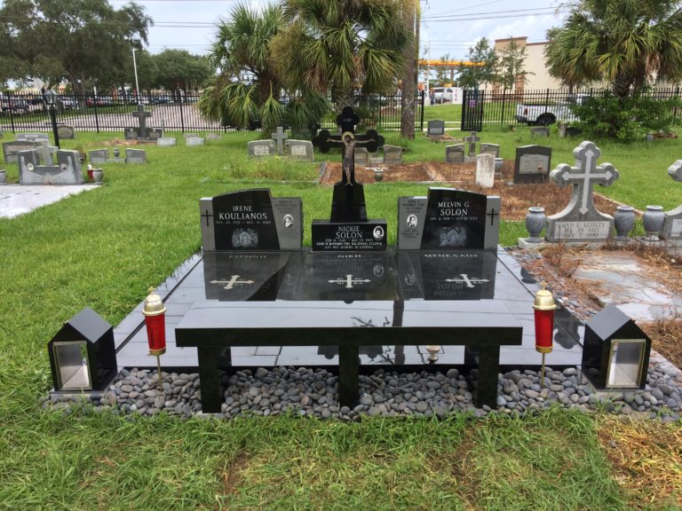 black granite lot with candlehouses and bench