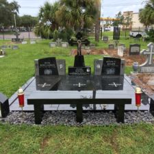 black granite lot with candlehouses and bench